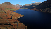 Aerial tracking shot over Wast Water, looking towards Wasdale Head and Scafell Pike, Lake District National Park, Cumbria, UK.