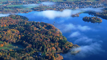 Aerial shot of Derwentwater, its surrounding woodland and Keswick town, Lake District National Park, Cumbria, UK.