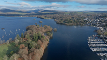 Drone shot of Windermere town, Belle Isle and Lake Windermere, Lake District National Park, Cumbria, UK.