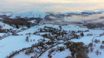 Aerial shot of the snow covered landscape around Grasmere village, Lake District National Park, Cumbria, UK.