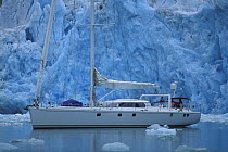 88ft sloop "Shaman" dwarfed by a wall of glaciers in Spitsbergen, Svalbard, Norway, 1998.