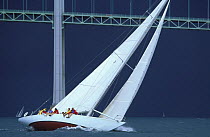 12 metre "Weatherly" hard on the wind in stormy weather in front of the Newport bridge, during the Museum of Yachting's annual regatta, Newport, Rhode Island, USA.