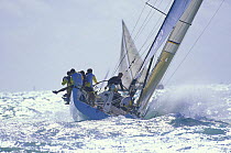 Crew sitting on the windward gunwale, racing upwind in breezy conditions at Key West Race Week, Florida, USA 2001