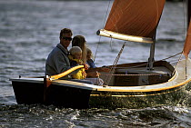 Young family sailing a Point Jude daysailor, Rhode Island, USA