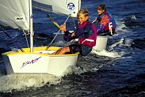 Two children sailing Optimist prams in Florida, USA