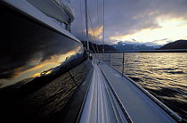 Late afternoon reflections on the cabin windows of 88ft sloop "Shaman", Alaska. 2001