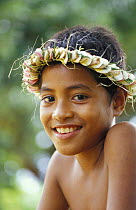 Young boy wearing a traditional flower headdress. Yap, Micronesia.