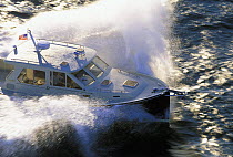 A True North 39 powerboat ploughing through a wave.