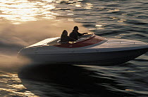 Small speed boat travelling at high speed.
