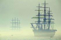 Two Tall ships in fog during Boston tall ships parade, Massachusetts, USA. ^Amerigo Vespucci^ is in the foregound.