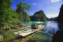 Bangka, traditinal outrigger boat on shore of Kayangan Lake, Philippines.
