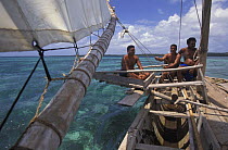 Men sailing a popow, the traditional outrigger canoe used on Yap. The popow is characterized by v shaped ends, and is used for travel and fishing. The popows are designed so that the mast can be moved...