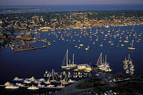 Newport Harbour with Goat Island in the foreground, the Newport waterfront and in the distance, Middletown, Rhode Island, USA.