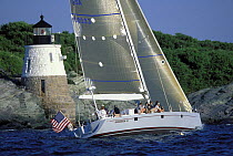 Brigadoon VI sailing past the Castle Hill Lighthouse near Newport, Rhode Island, USA.
