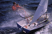 Two people trapezing on a One Design 14 foot dinghy.