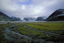 88ft sloop "Shaman", anchored near a glacier whilst the crew explore Magdalena Fjord, Spitsbergen, Svalbard, Norway, 1998.