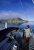Helming 88ft yacht "Shaman" through the islands of Spitsbergen, Svalbard, Norway, 1998.