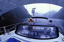 88ft sloop "Shaman" motoring through Fjordland, South Island, New Zealand, 2001.