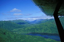 Aerial view of Kodiak island, Alaska and wing of airplane. 2001