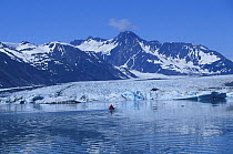 Kayaking beneath mountains. Bear Glacier, Kenai Fjords National Park, Alaska. 2001.