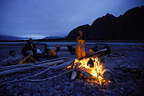 Shaman crew around a beach camp fire near Bear Glacier, Kenai Pensula, Alaska. 2001