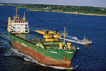 Tanker "Amanda", with pilot boat in attendance, leaves Narragansett Bay, Rhode Island, USA. passing Castle Hill Lighthouse in Newport.