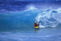 A bodyboarder catches a wave in Hawaii