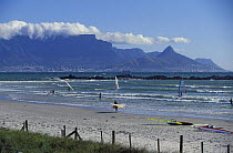 Windsurfers on Table Bay, with Table Mountain in the background. Cape Town, South Africa.