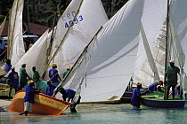 Workboats leaving the beach during the Grenada Sailing Festival, Caribbean.
