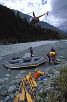 Helicopter dropping off a team of white water rafters in South Island, New Zealand. 1997