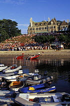 Tenders moored in the foreground, as crowds watch from the New York Yacht Club's (NYYC) clubhouse, Harbour Court, on Newport Harbour, Rhode Island.