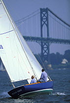 Classic Sea Sprite 23ft keelboat "Scot Free" sails towards the Bristol Bridge, Rhode Island, USA.