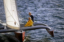 Couple sailing a cruising trimaran.