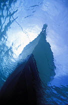 Underwater view of an anchored powerboat