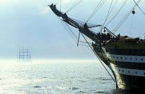 The bow of "Amerigo Vespucci" and a tall ship in fog during the Boston Tall ships parade, Massachusetts, USA