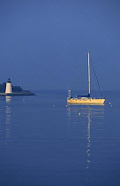 Yacht Anchored off Goat Island lighthouse, Newport, Rhode Island, USA.