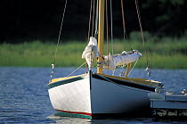 A small sailboat alongside the dock in Osterville, Cape Cod, USA.