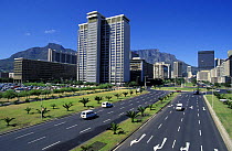 Skyscrapers and motorway in downtown Cape Town, overlooked by Table Mountain behind, South Africa.
