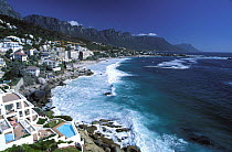Atlantic waves on shores of Clifton beach, with the Twelve Apostles mountain range in the background, Cape town, South Africa.