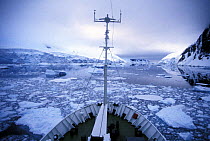 View from the bow of the Russian expedition cruise ship "Professor Molvanov", making progress through the icy Gerlache Strait, Antarctic Peninsula.