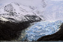 A glacier fills in rock crevices in the Chilean waterway.