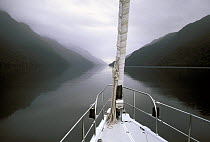 The 88 foot sloop, "Shaman", exploring Fiordland, South Island, New Zealand. Property Released.