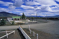 A crossroads and fence in Patagonia marking the point where the Argentina and Chile borders meet.