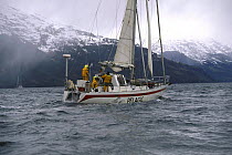 Skip Novak yacht "Pelagic" motorsailing down the Beagle Channel, Chile.