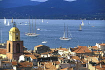 Classic yachts beginning to hoist their sails at the start of a day's racing in La Nioulargue regatta (Les Voiles de Saint-Tropez), St Tropez, France.