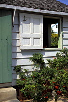 Open shutters on a Bahamian-style house in Great Guana Cay, Caribbean.