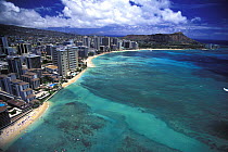 Aerial view of high rise hotels and skyscrapers along Oahu's Waikiki Beach, all the way to the extinct volcano at Diamond Head, Honolulu, Hawaii.