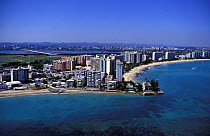 The high rises of San Juan towering over the city's long sandy shores, Puerto Rico, Caribbean.