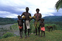 The chief of Jenitovara village in the Vanuatu islands poses with his family. Pacific Islands.
