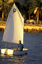 Young boy sailing an Optimist dinghy during training in Florida, USA